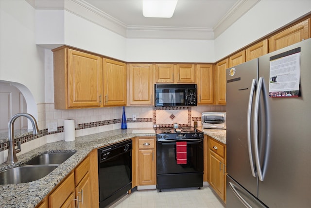 kitchen featuring black appliances, light stone counters, ornamental molding, and sink