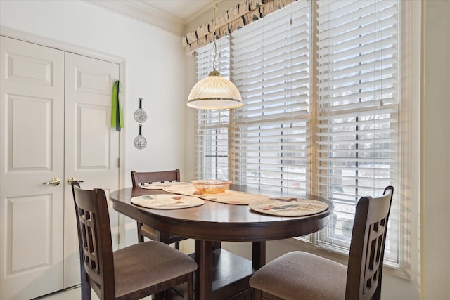 dining room featuring plenty of natural light and crown molding