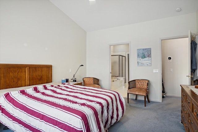 bedroom featuring carpet flooring, ensuite bath, and lofted ceiling