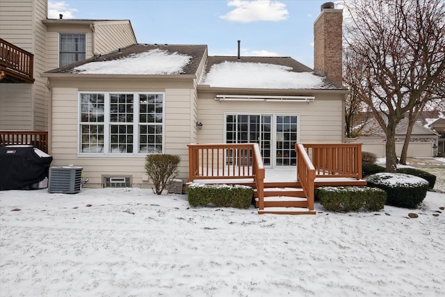 snow covered property featuring a deck and central air condition unit