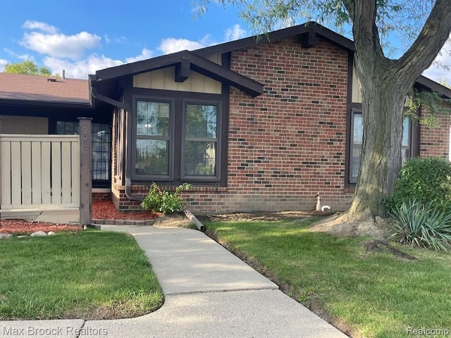 entrance to property featuring a lawn