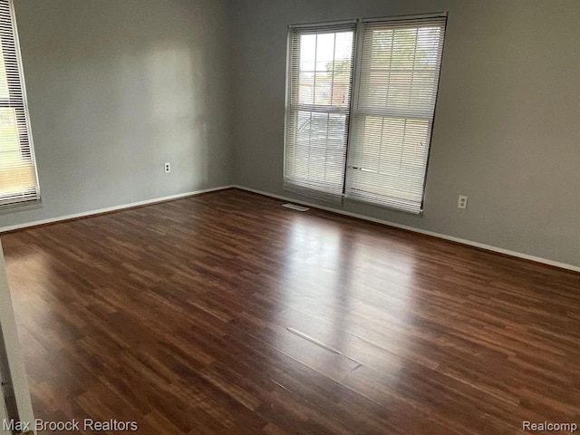 empty room featuring dark hardwood / wood-style flooring