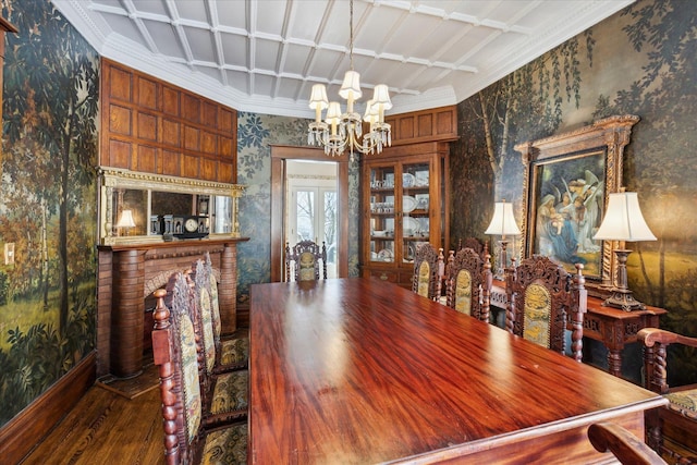 dining space featuring coffered ceiling, a brick fireplace, an inviting chandelier, hardwood / wood-style floors, and ornamental molding