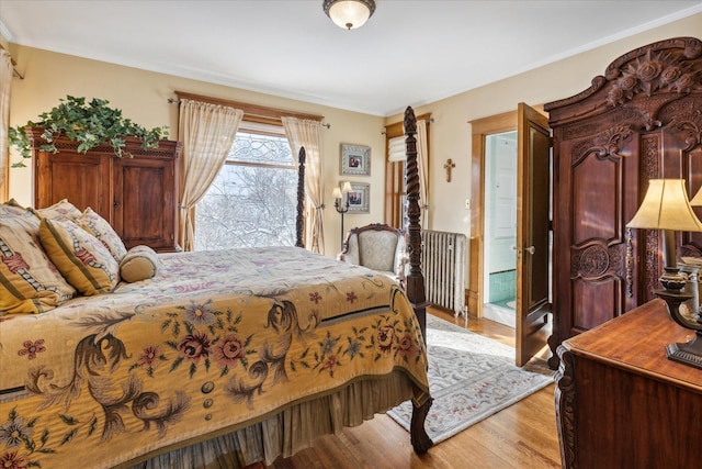 bedroom featuring light hardwood / wood-style floors and radiator