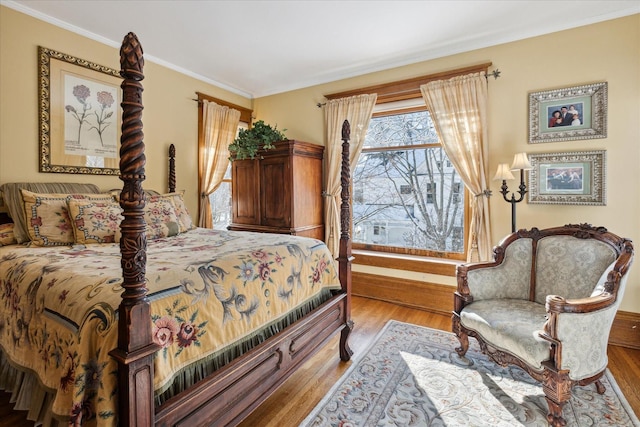 bedroom with crown molding and light hardwood / wood-style flooring