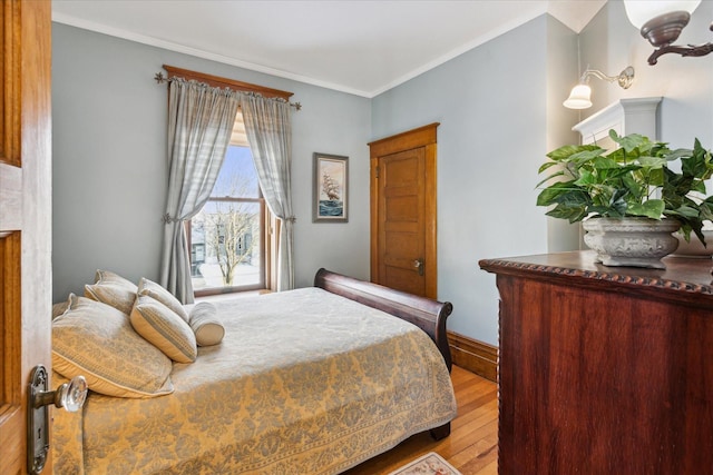 bedroom featuring light hardwood / wood-style floors and ornamental molding