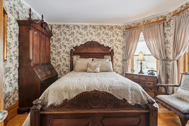 bedroom featuring wood-type flooring and ornamental molding