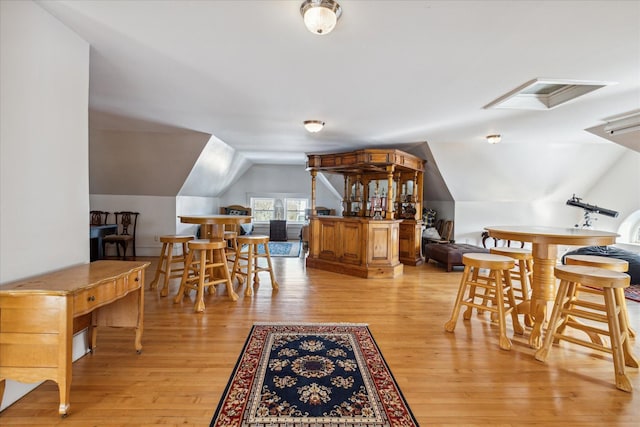 interior space with light wood-type flooring and vaulted ceiling