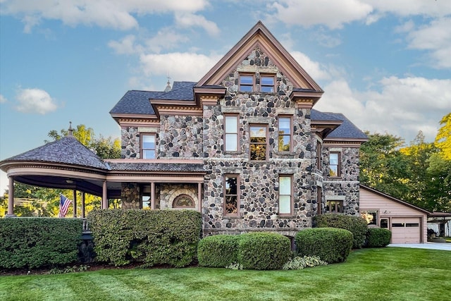 view of front of property featuring a garage and a front lawn