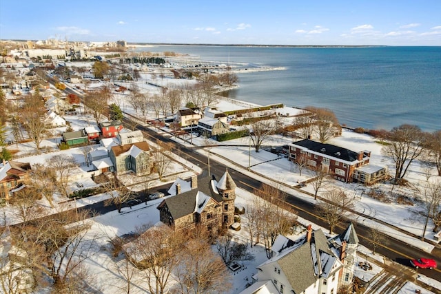 snowy aerial view featuring a water view