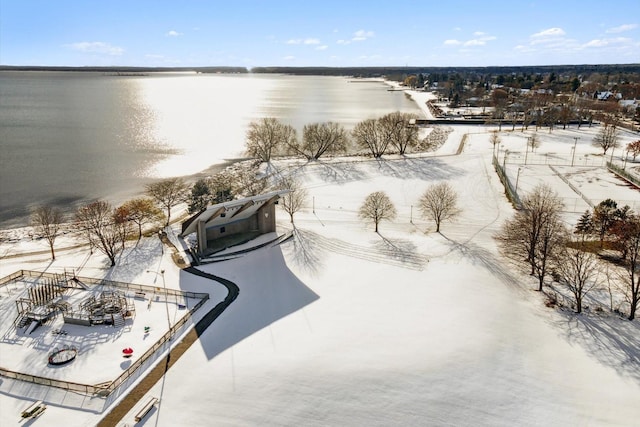 snowy aerial view featuring a water view