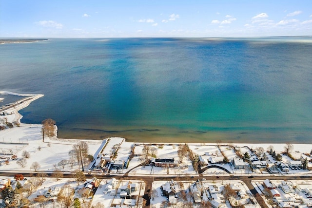 drone / aerial view featuring a beach view and a water view