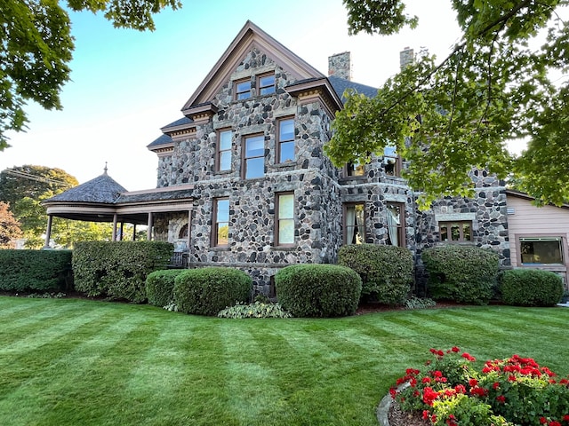 rear view of property with a yard