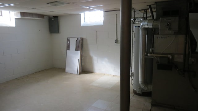 basement featuring gas water heater and electric panel