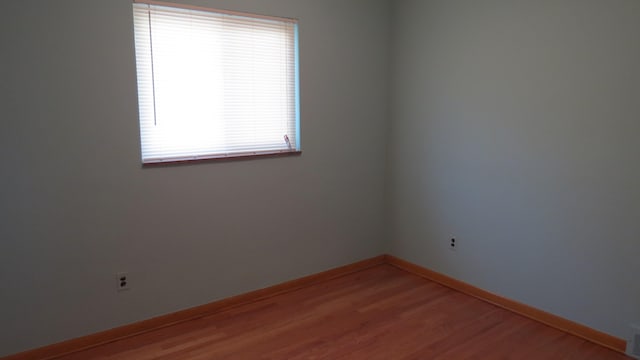 unfurnished room featuring hardwood / wood-style flooring and a healthy amount of sunlight