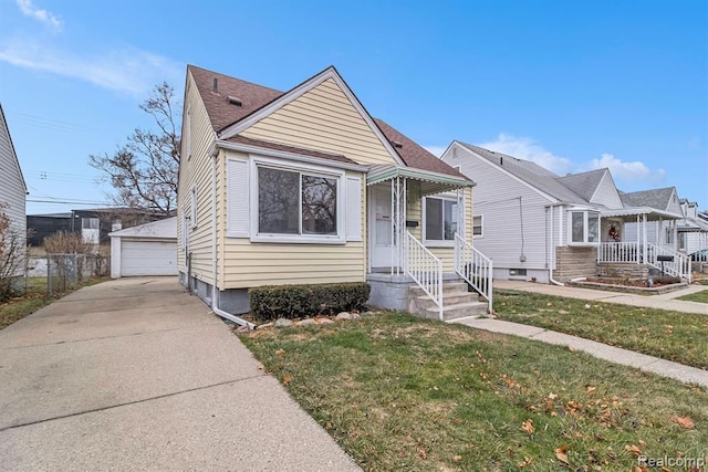 bungalow-style house with a garage, an outdoor structure, and a front lawn