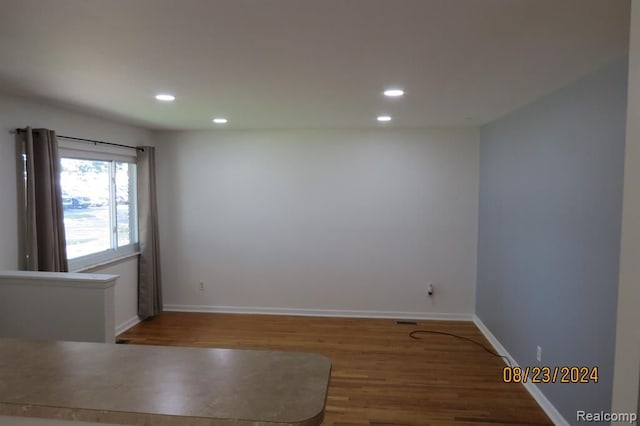 spare room featuring wood-type flooring