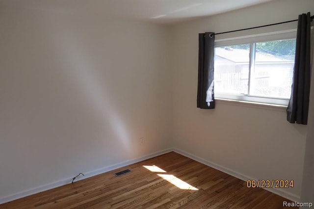 empty room with hardwood / wood-style floors