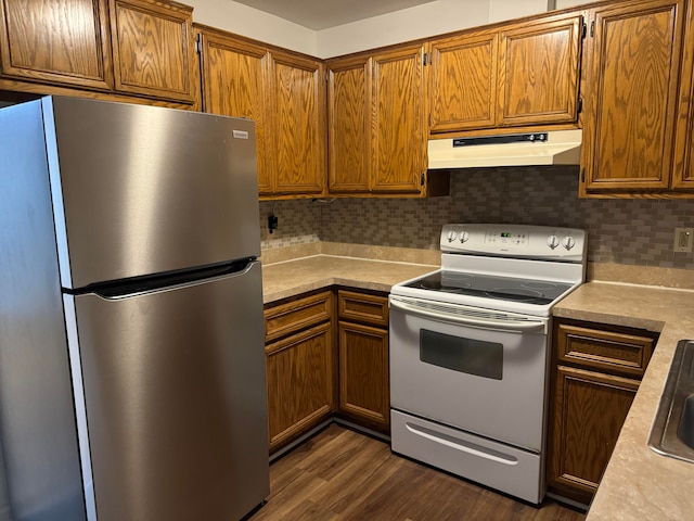 kitchen featuring tasteful backsplash, electric stove, stainless steel fridge, and dark hardwood / wood-style flooring