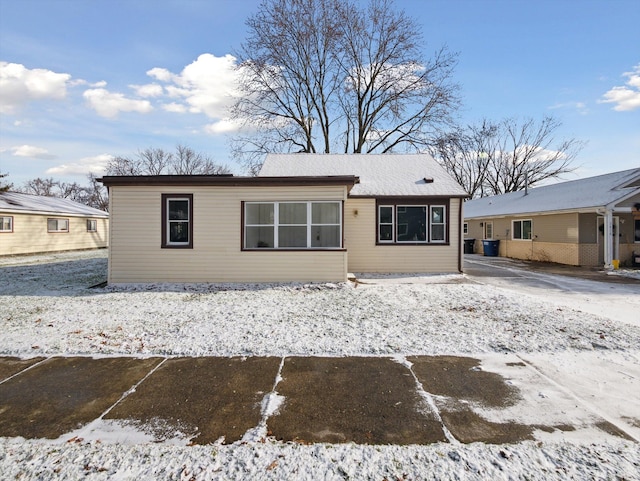 view of snow covered back of property