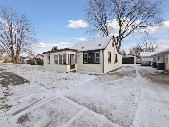 view of front facade featuring a garage and an outbuilding