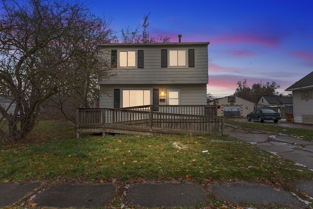 view of front facade featuring a lawn and a deck