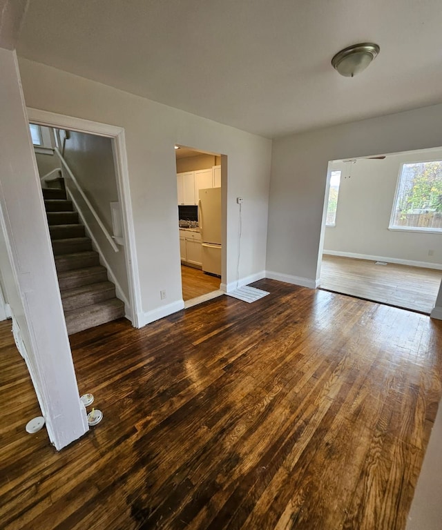 unfurnished living room featuring wood-type flooring