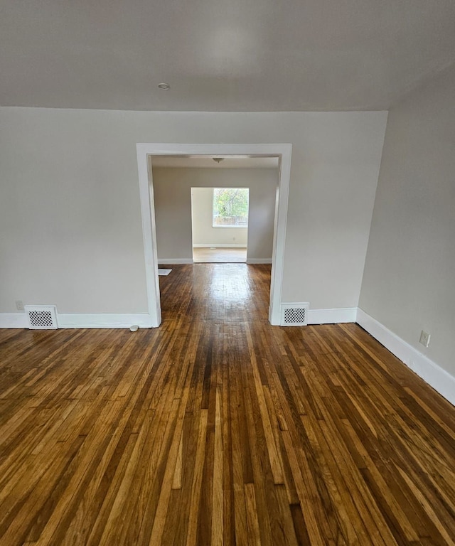 spare room featuring dark wood-type flooring