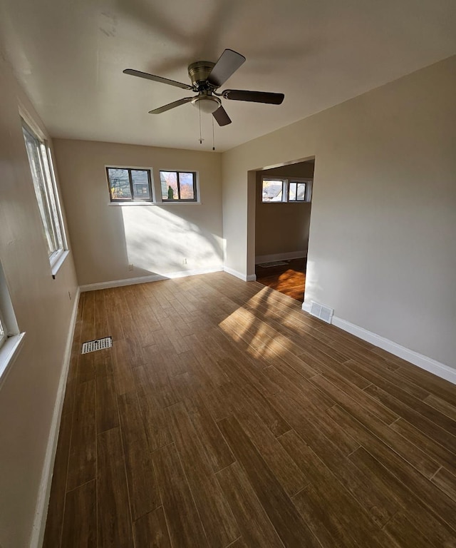 empty room featuring dark hardwood / wood-style flooring and ceiling fan