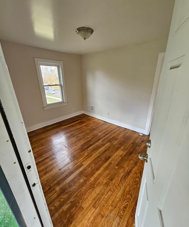 empty room featuring wood-type flooring