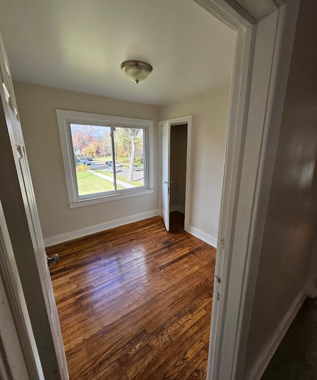 unfurnished bedroom featuring dark hardwood / wood-style floors