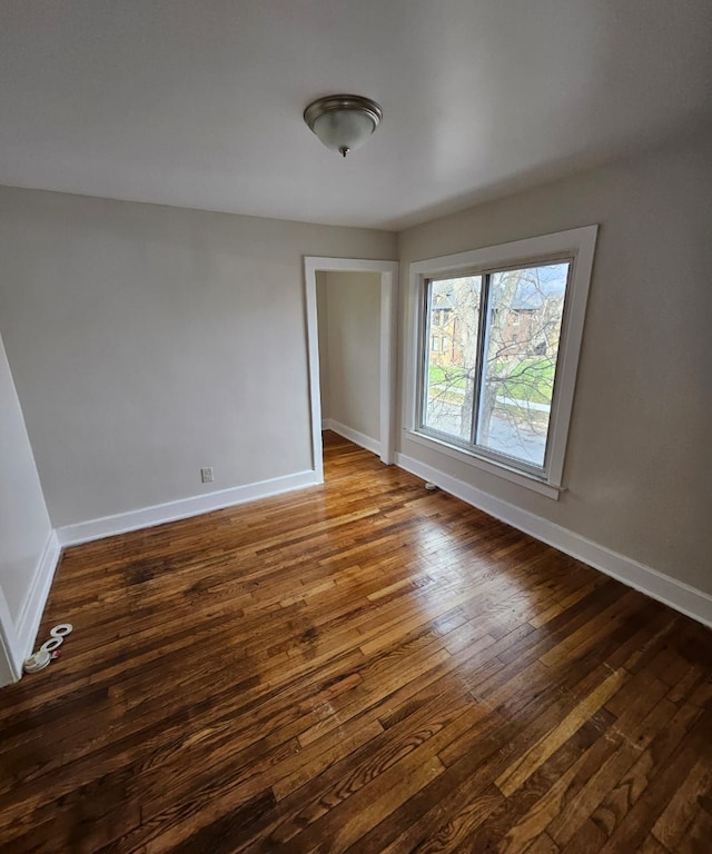 spare room featuring dark wood-type flooring