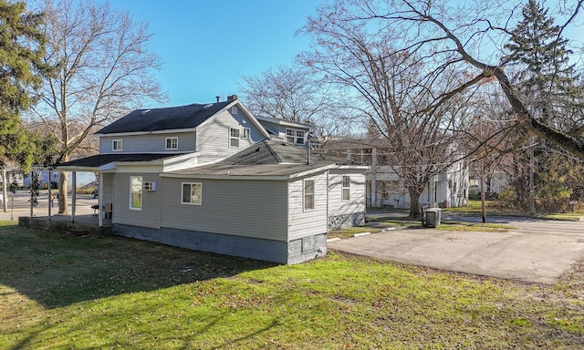 view of side of property with a yard