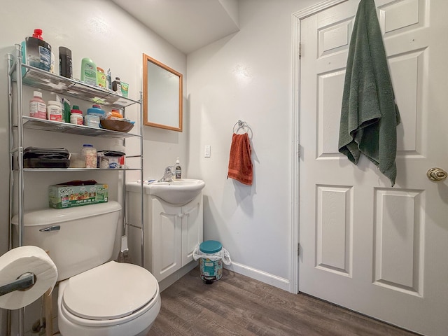 bathroom featuring hardwood / wood-style floors, vanity, and toilet