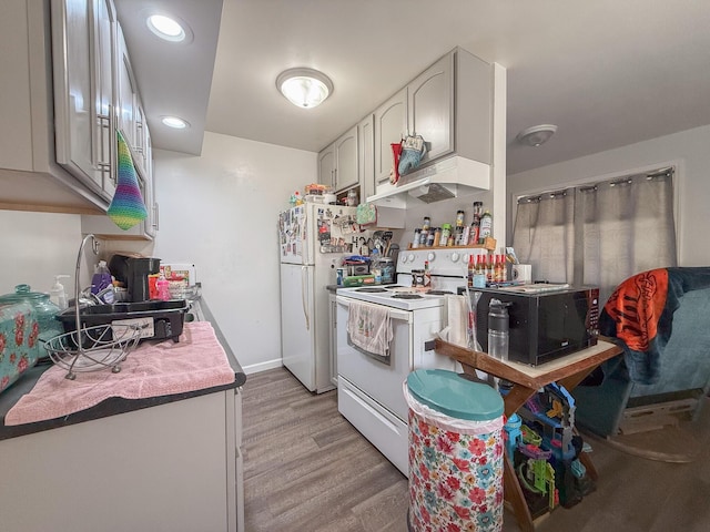 kitchen with custom range hood, light hardwood / wood-style floors, and white appliances