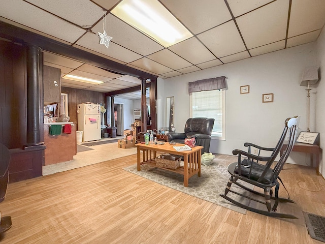 living area with light hardwood / wood-style flooring and a drop ceiling