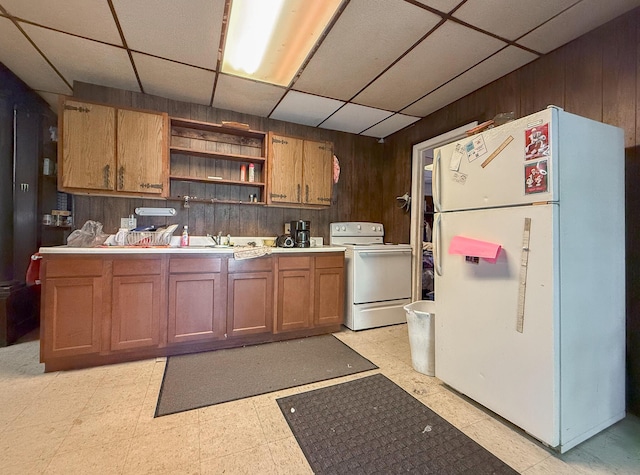 kitchen with wood walls and white appliances