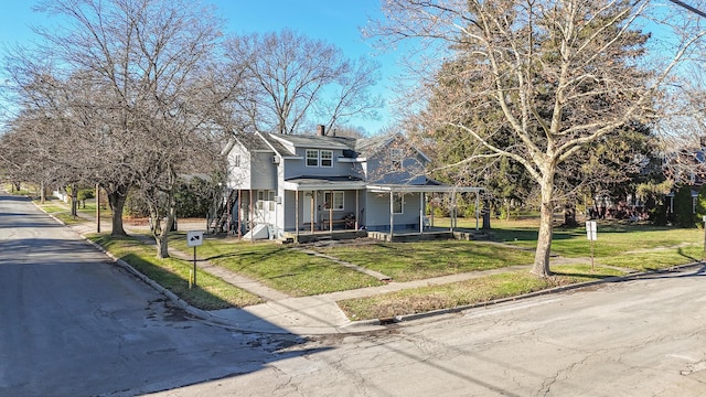 view of front facade with covered porch and a front yard