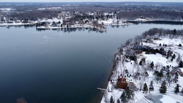 snowy aerial view with a water view