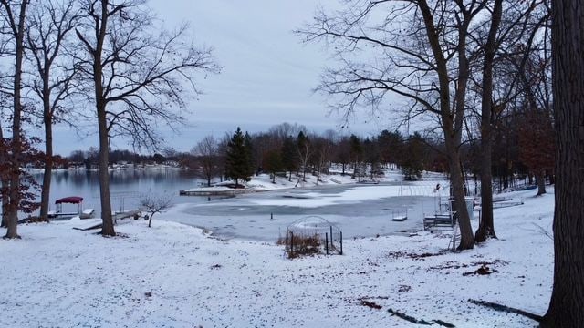 snowy yard with a water view