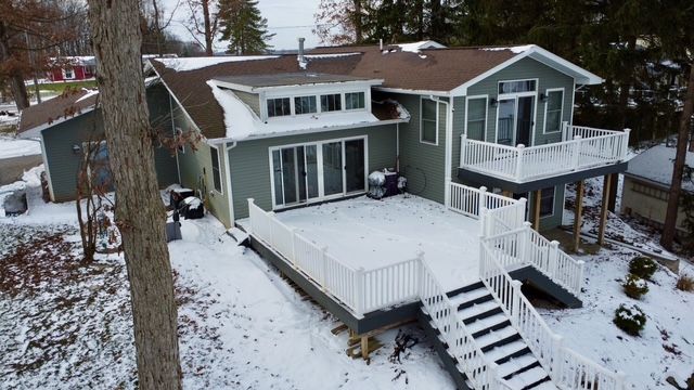 snow covered property featuring a wooden deck