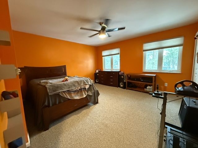 carpeted bedroom with ceiling fan