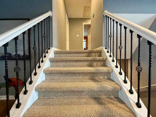 stairs featuring hardwood / wood-style floors