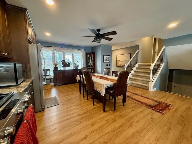 9471 Ridge Rd, Goodrich, MI 48438 - dining room featuring light wood finished floors, ceiling fan, stairs, and recessed lighting
