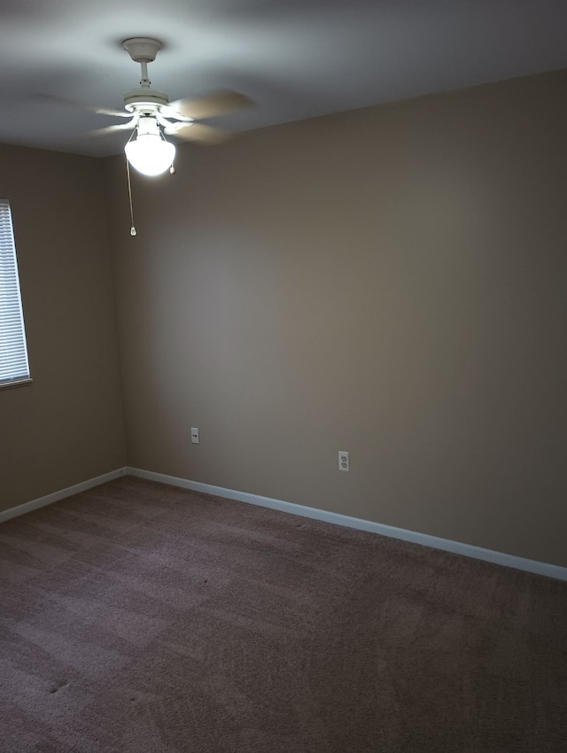 empty room featuring ceiling fan and carpet floors