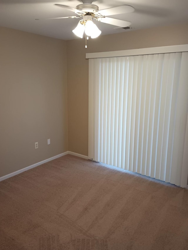 carpeted empty room featuring ceiling fan