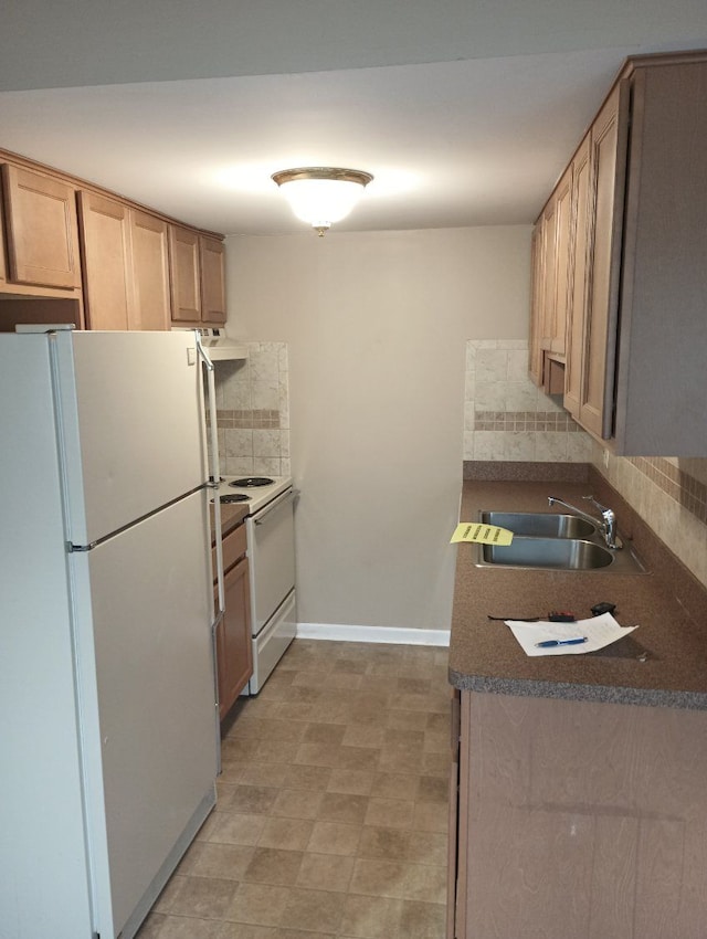 kitchen with backsplash, white appliances, sink, and light brown cabinetry