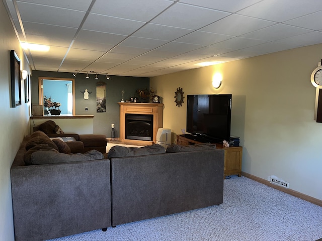 carpeted living room with track lighting