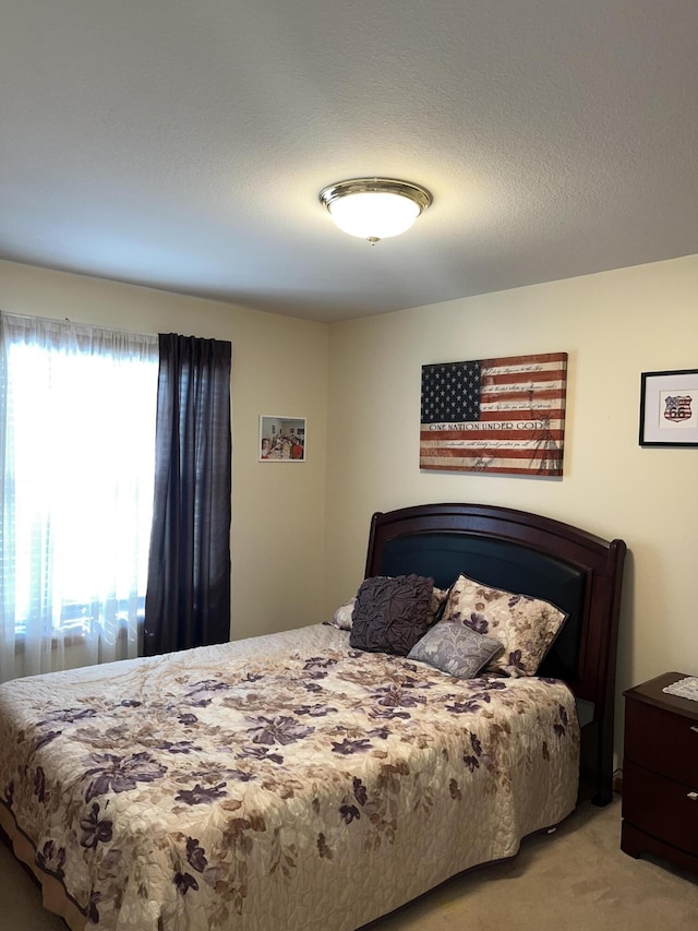 carpeted bedroom featuring a textured ceiling