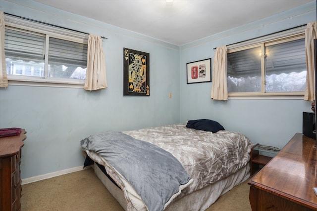 bedroom with light colored carpet and ornamental molding